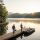 Stone cottage by a lake with a wooden dock; two men walk with fishing rods toward small boats at sunrise. Home Maintenance Concierge Services