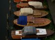 Boats protected with canvas covers beside a wooden dock