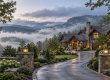 Highlands mountain home surrounded by misty mountains illustrating local home oversight for absentee owners.